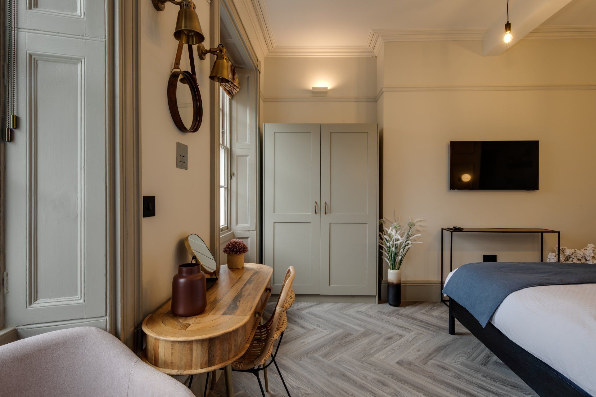 A bedroom with a bed , desk , chair and television.