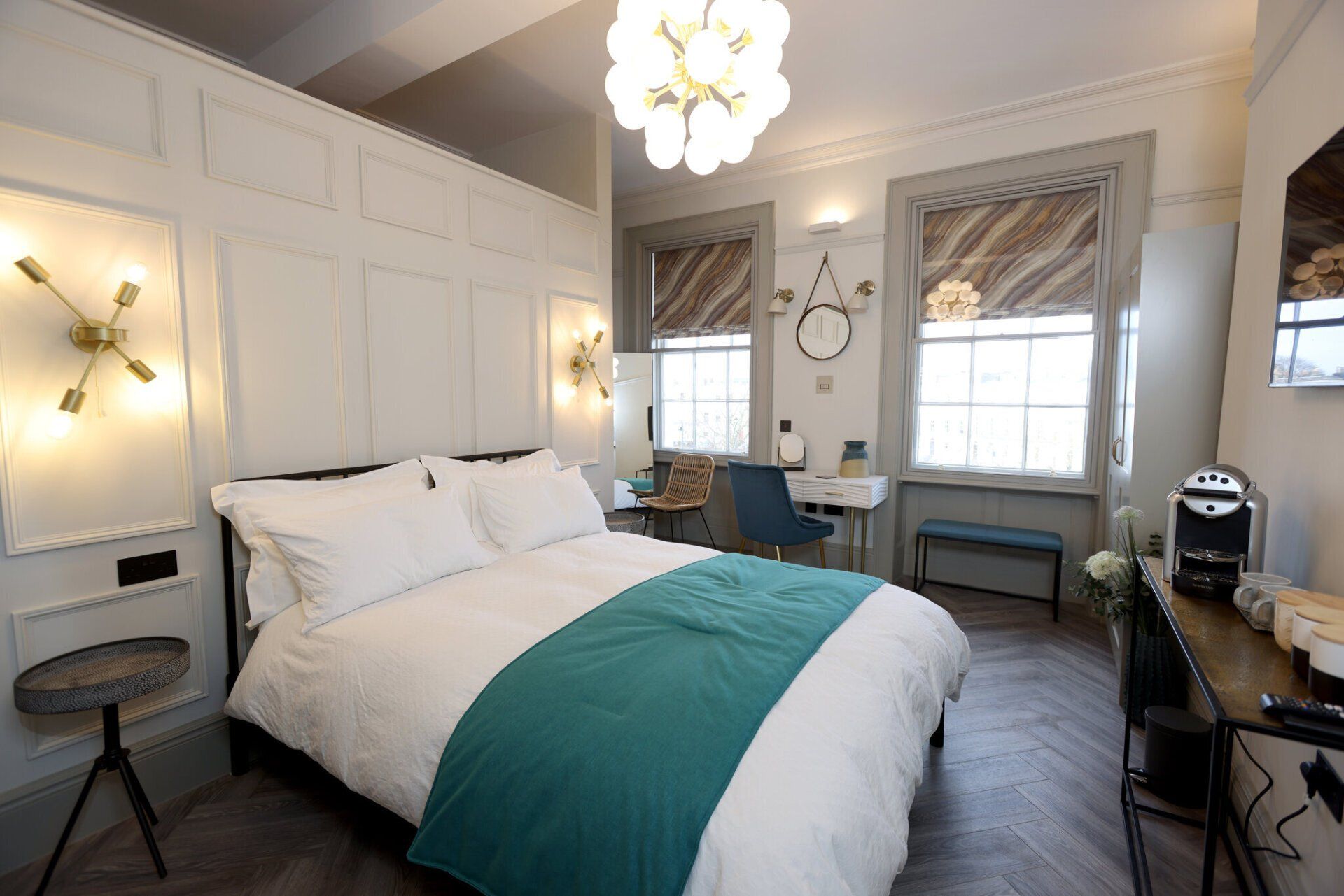 A bedroom with a bed , desk , chair and window.