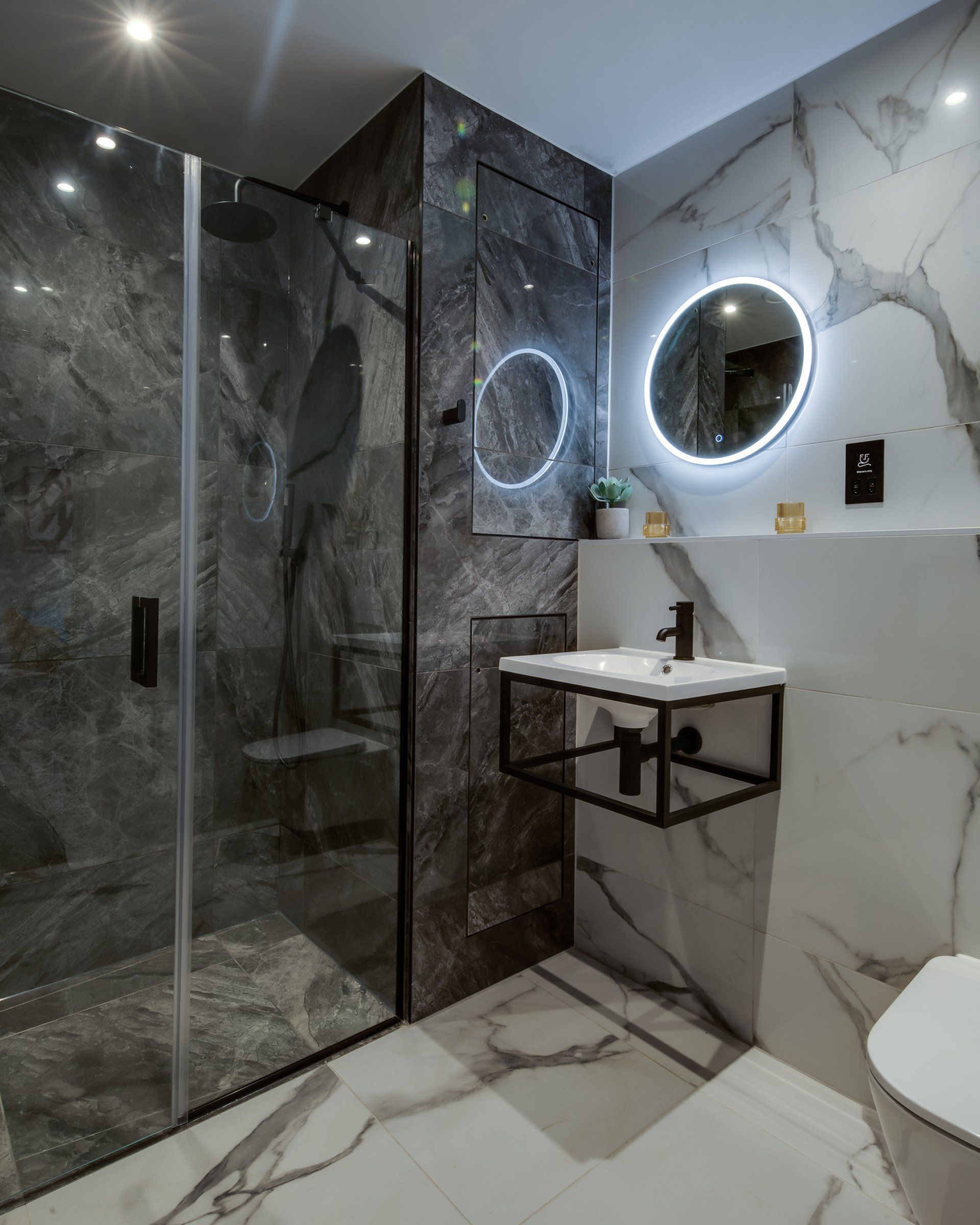 A bathroom with a walk in shower , sink and toilet
