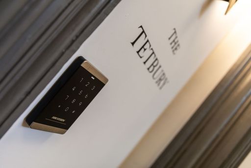 A keypad on a wall that says the tetbury