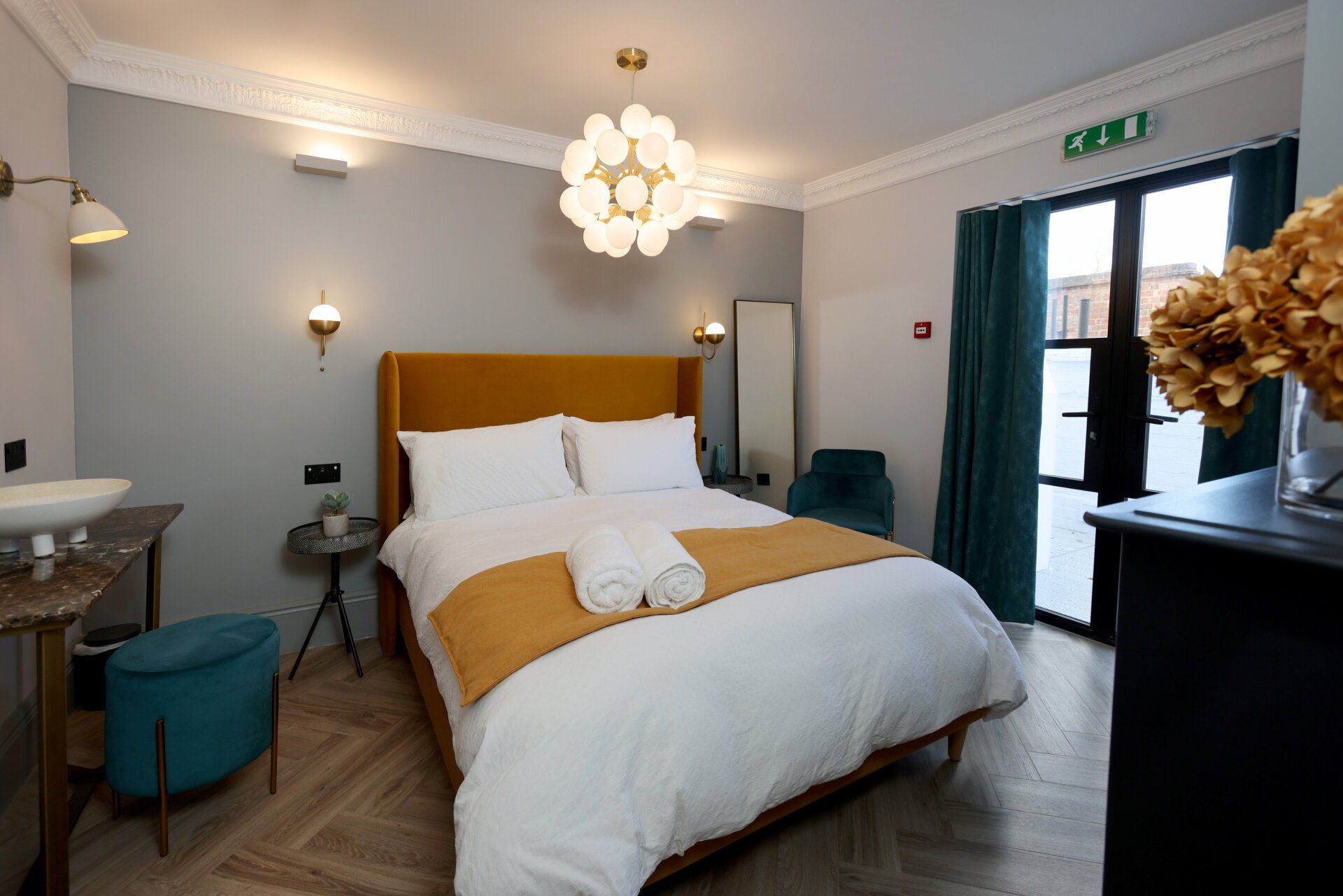 Neptune Apartments luxury apartment inside view,  large bed dressed in white linen with mustard blanket