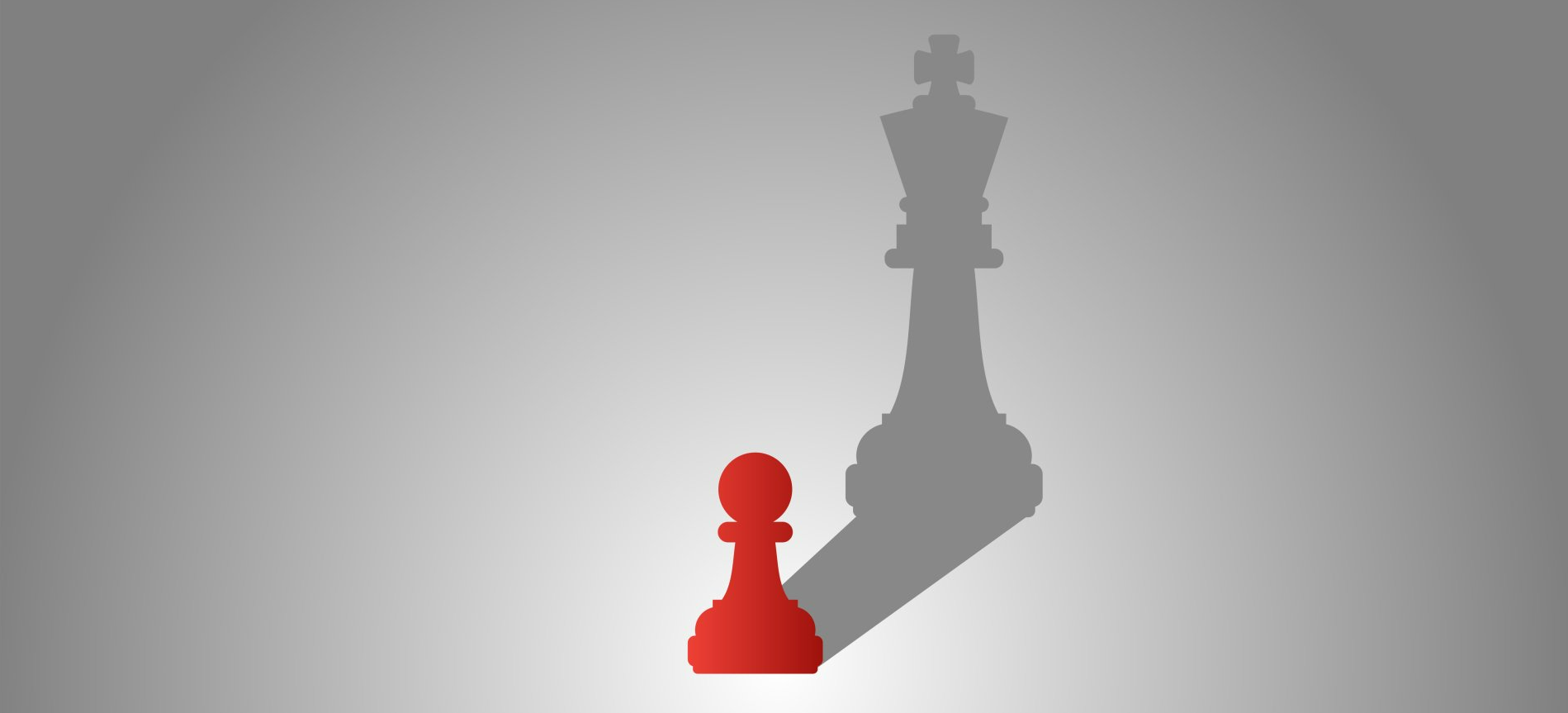 The shadow of a king chess piece is cast on a red pawn.