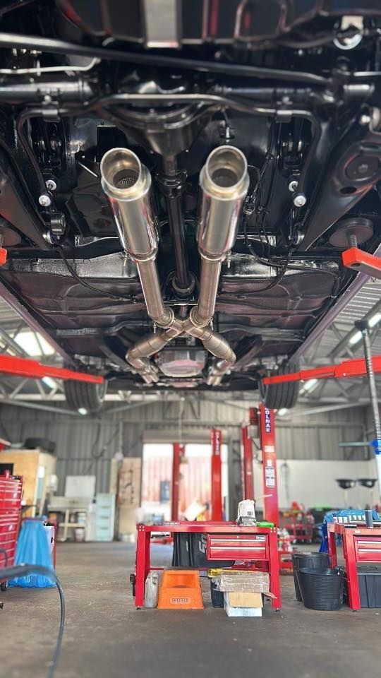 A Car Is Sitting On A Lift In A Garage — Hervey Bay Service Centre in Pialba, QLD