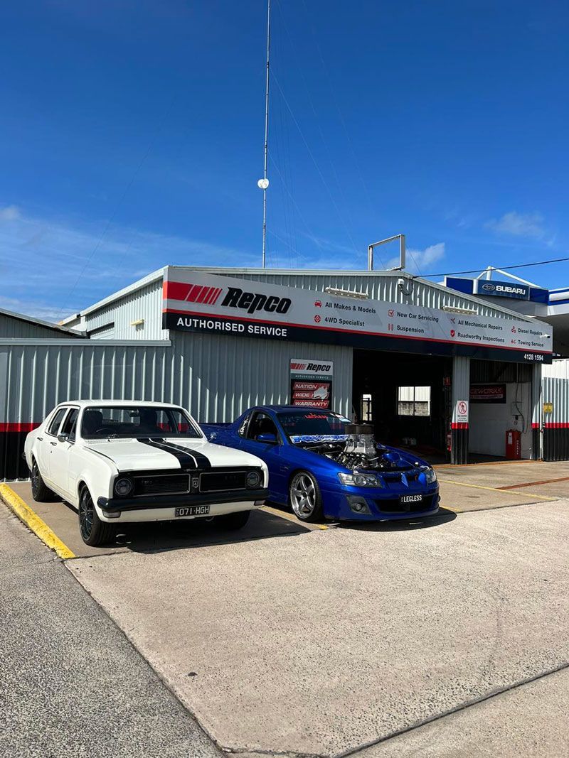 Two Cars Are Parked In Front Of A Garage — Hervey Bay Service Centre in Pialba, QLD