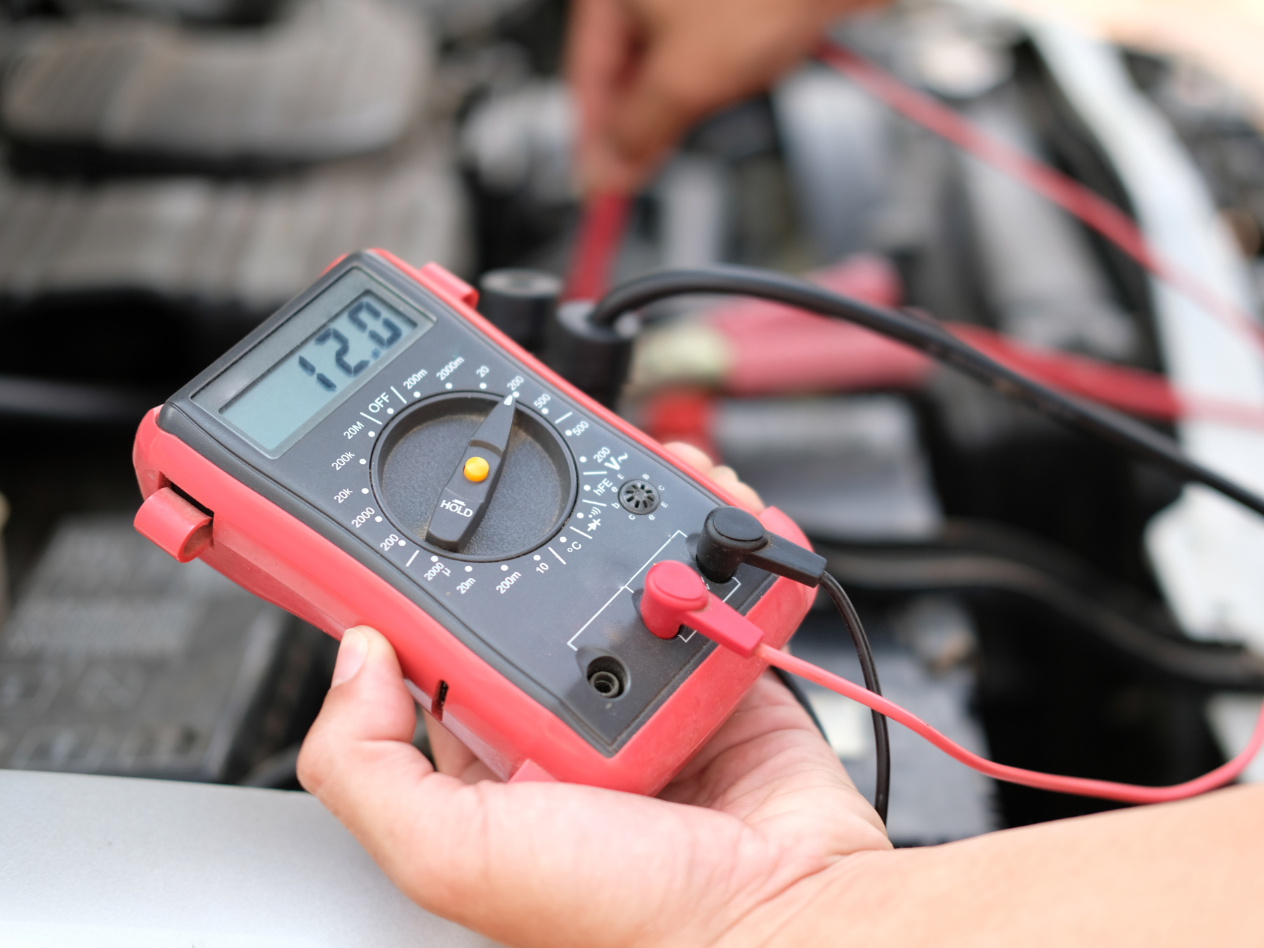 A Blue Car Is Parked On A Red Lift in A Garage — Hervey Bay Service Centre in Pialba, QLD