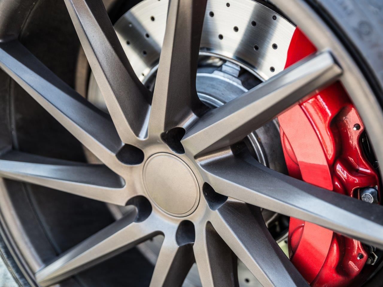 Mechanic Working On A Car Brake — Hervey Bay Service Centre in Pialba, QLD