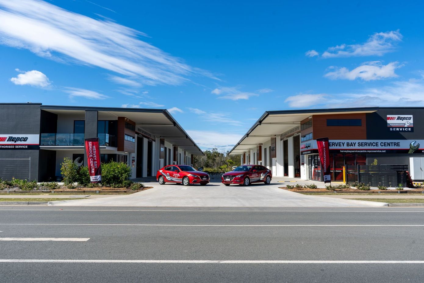 2 Red Sedans out the front of the office — Hervey Bay Service Centre in Pialba, QLD