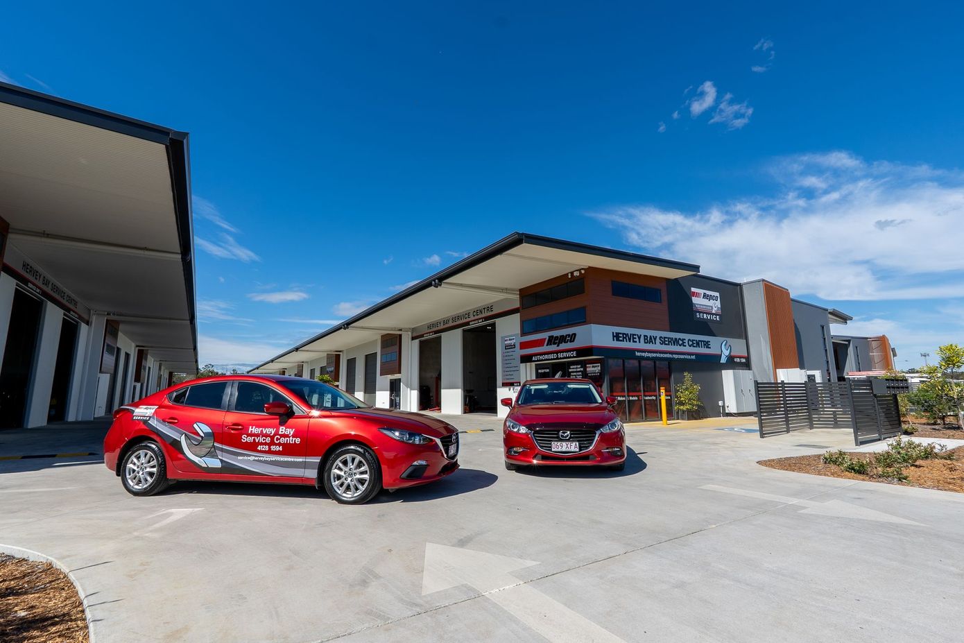 2 Red Sedans out the front of the office — Hervey Bay Service Centre in Pialba, QLD
