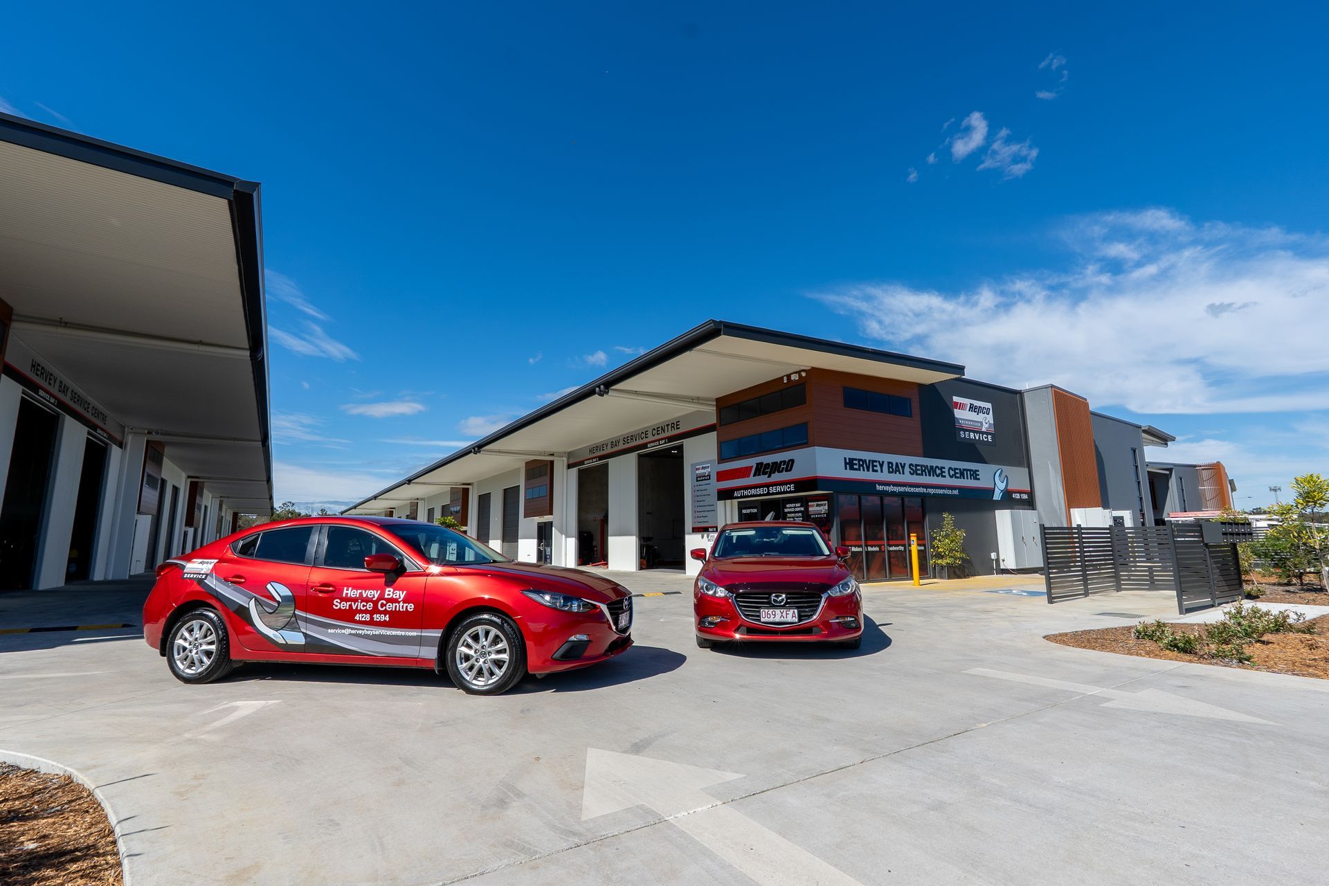 Two Red Sedans out the front of the Office — Hervey Bay Service Centre in Pialba, QLD