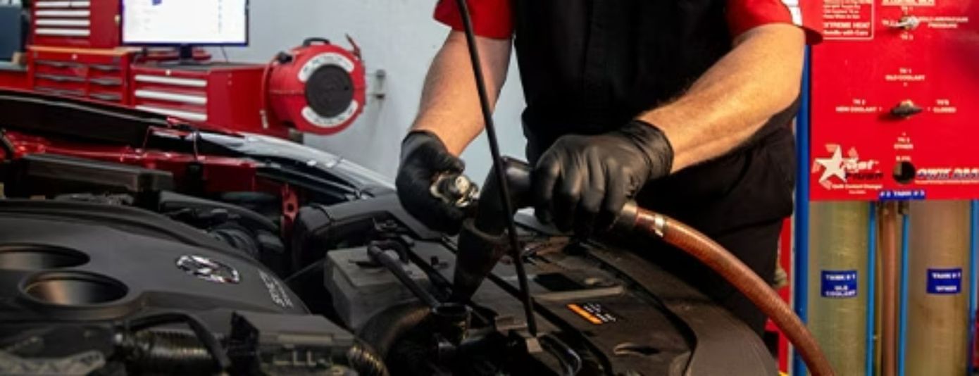 A Man Is Working On A Car Engine In A Garage — Hervey Bay Service Centre in Pialba, QLD