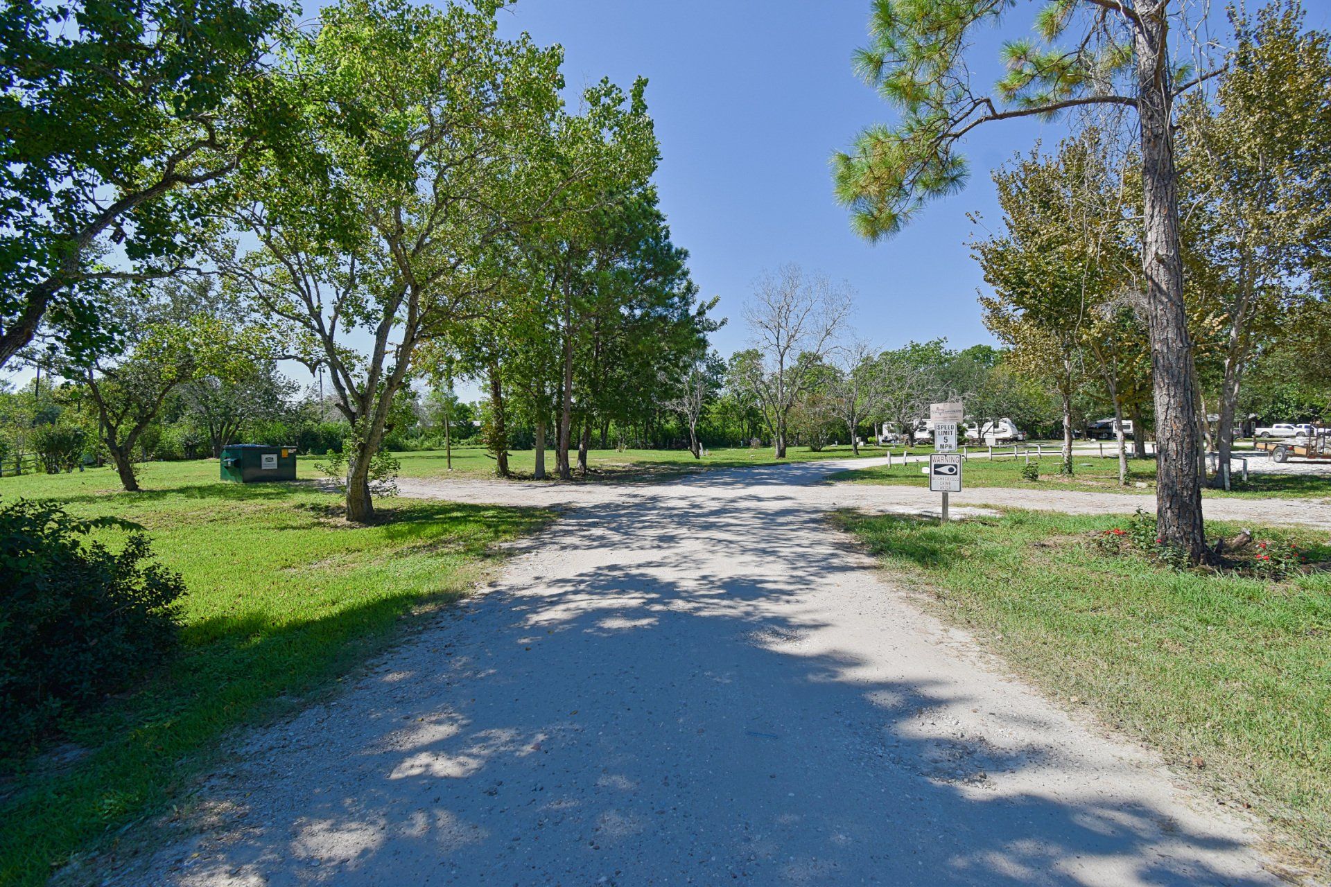 Reception desk in a building with wood paneling, light wood floors, and neutral walls.