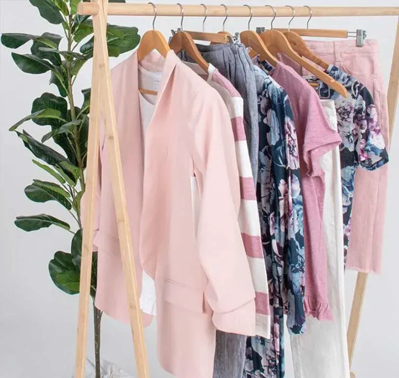 Clothes Hanging on a Rack With a Plant in the Background — Onyx Poppy Boutique in Buderim, QLD