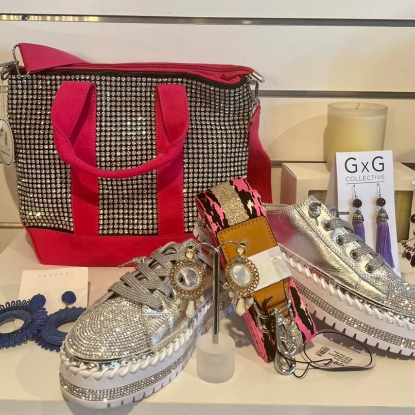 A GXG Collection Sign is Next to a Pair of Shoes — Onyx Poppy Boutique Buderim in Sunshine Coast, QLD
