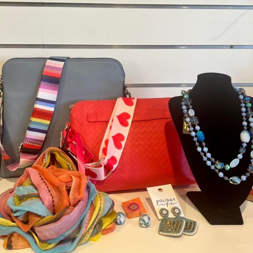 A Red Purse With Hearts on the Strap Sits Next to a Gray Purse — Onyx Poppy Boutique Buderim in Sunshine Coast, QLD
