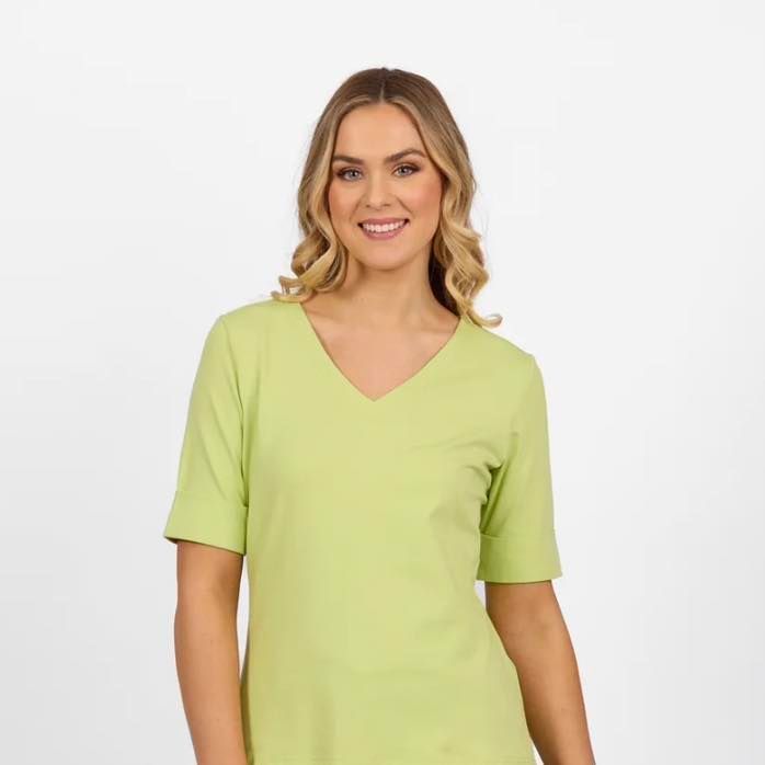 A Woman is Wearing a Green Shirt With a V-Neck and Short Sleeves — Onyx Poppy Boutique Buderim in Sunshine Coast, QLD
