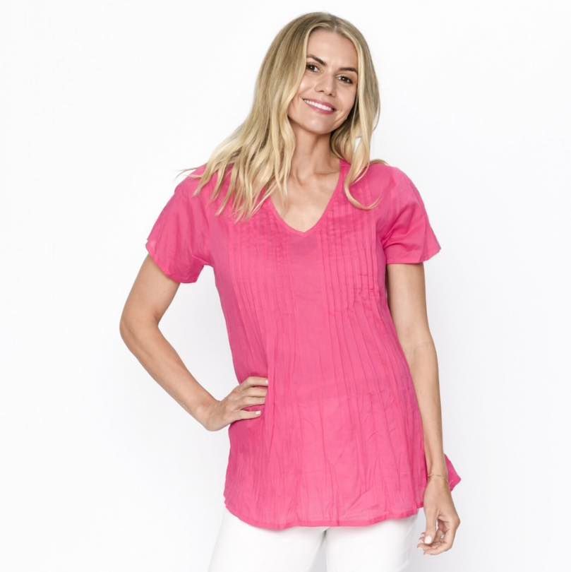 A Woman is Wearing a Pink T-shirt and White Pants — Onyx Poppy Boutique Buderim in Sunshine Coast, QLD