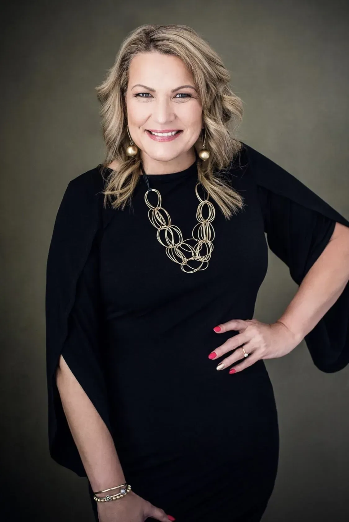 The Woman is Wearing a Black Dress and a Gold Necklace — Onyx Poppy Boutique in Buderim, QLD