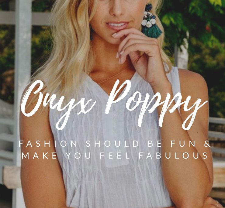 A Woman is Standing Next to a Sign That Says Onyx Poppy — Onyx Poppy Boutique Buderim in Buderim, QLD