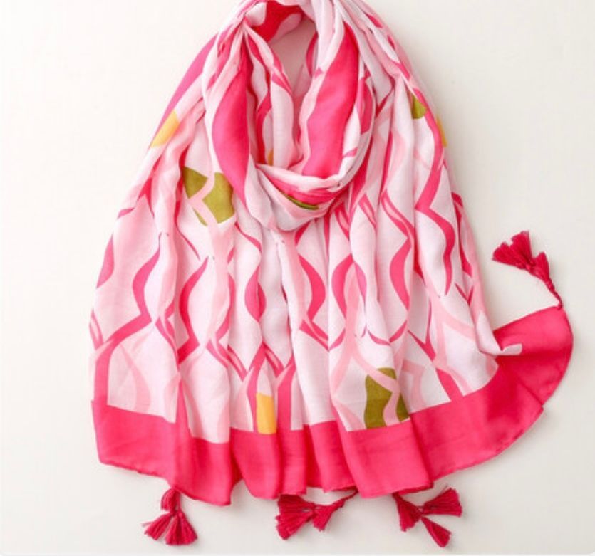 Pink and White Patterned Scarf With Tassels, Draped on a White Surface — Onyx Poppy Boutique in Buderim, QLD