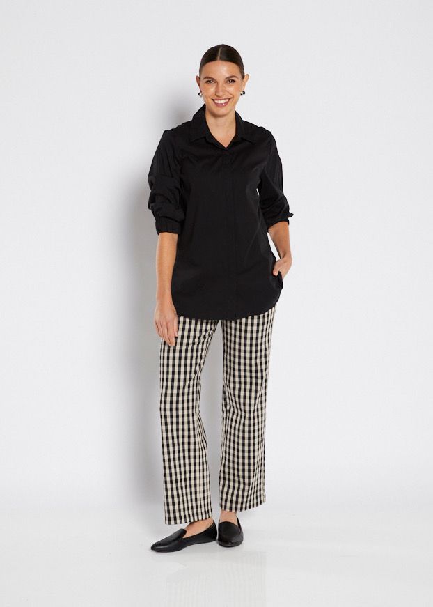 Woman in Black Top and Checkered Pants, Smiling, Standing in a Studio — Onyx Poppy Boutique in Buderim, QLD