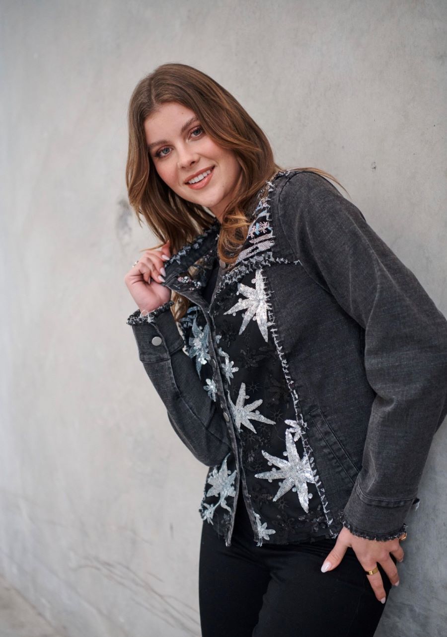 A Woman is Wearing a Black Jacket With Silver Stars on It — Onyx Poppy Boutique in Buderim, QLD