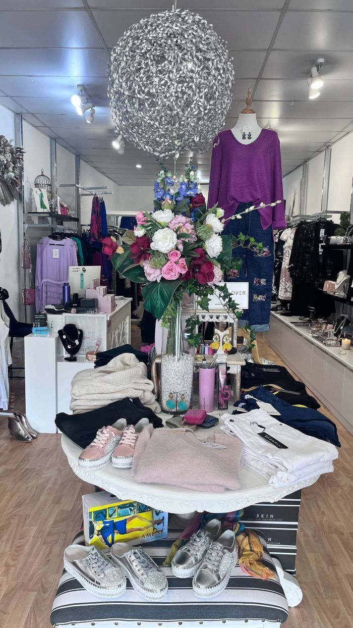 A Store Filled With Clothes With Flowers on It — Onyx Poppy Boutique Buderim in Buderim, QLD