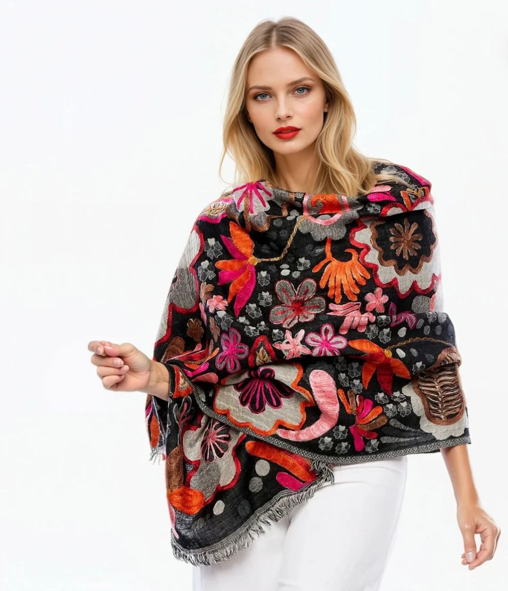 A Woman is Wearing a Colourful Poncho With Flowers on It — Onyx Poppy Boutique in Buderim, QLD