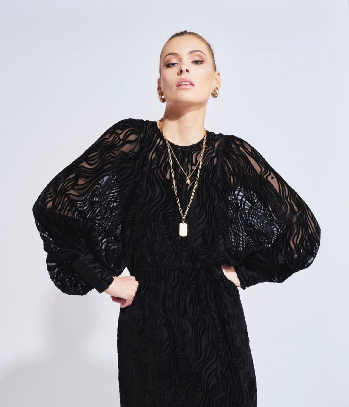 A Woman in a Black Dress is Standing in a Store — Onyx Poppy Boutique in Buderim, QLD