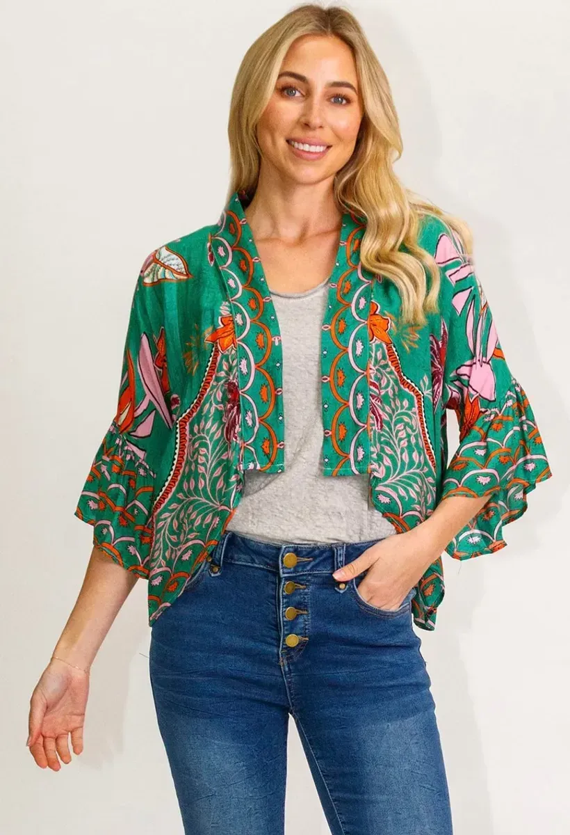 A Woman is Wearing a Green Kimono Jacket and Jeans — Onyx Poppy Boutique Buderim in Sunshine Coast, QLD