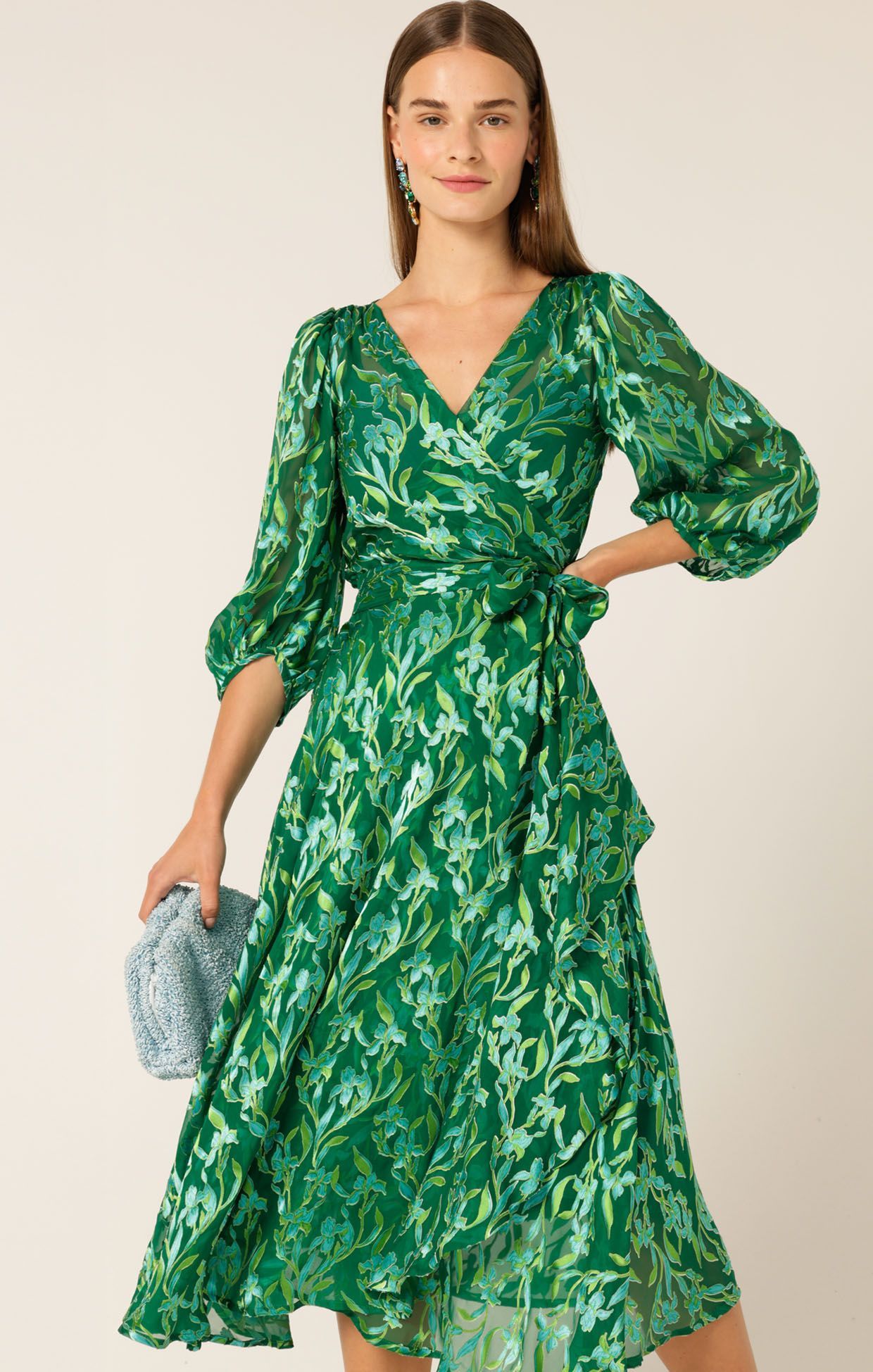 A Woman is Wearing a Green Floral Dress and Holding a Clutch — Onyx Poppy Boutique in Buderim, QLD
