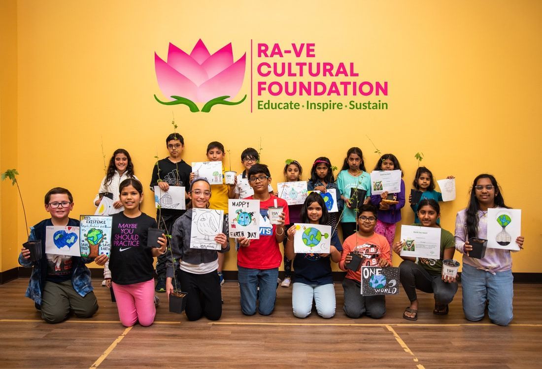 Group of children holding artwork in front of 