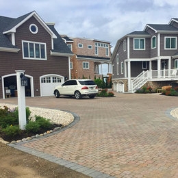 A white suv is parked in the driveway of a house