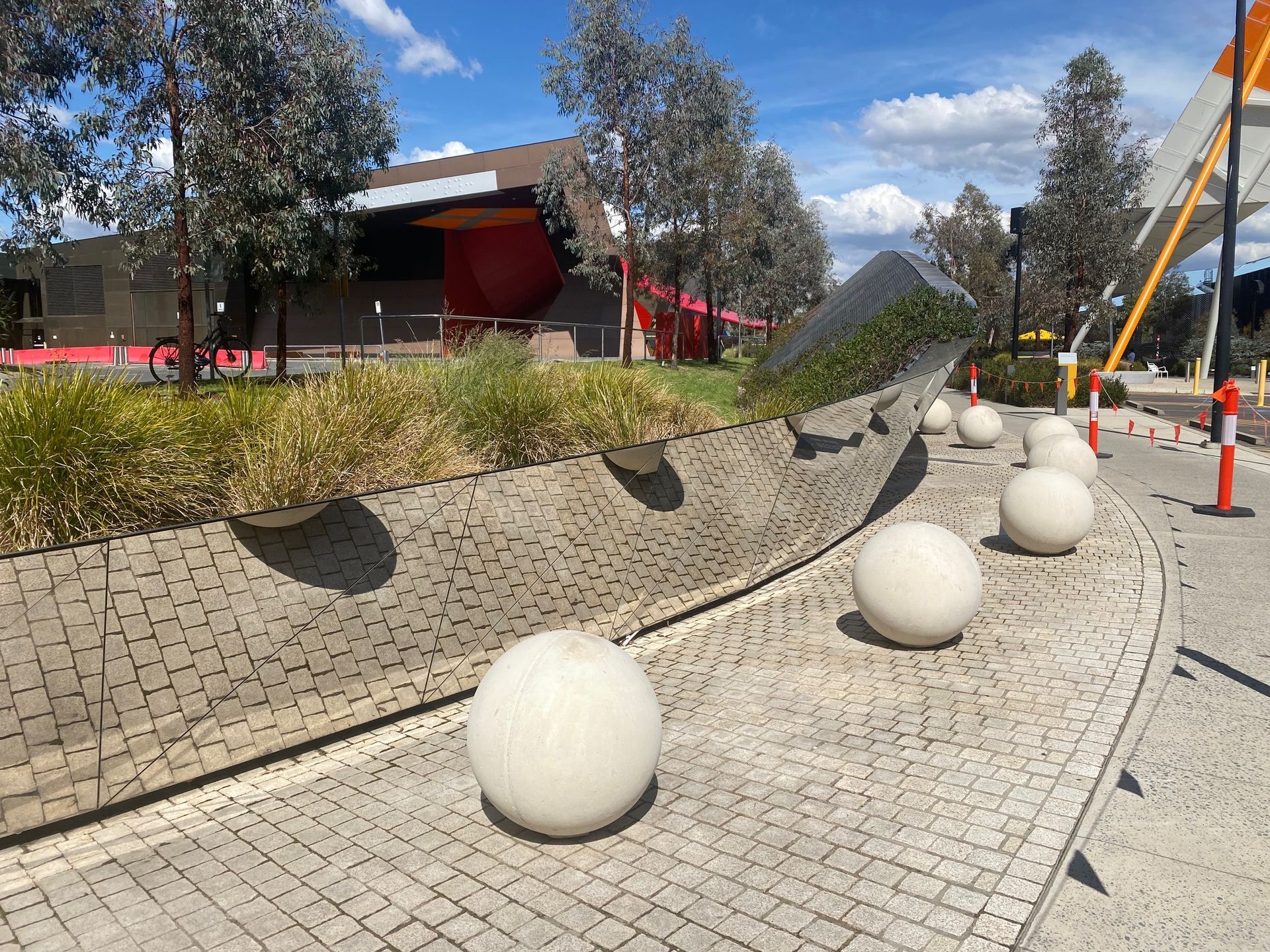 Large White Spheres Next To A Mirror On A Concrete Path— Precast Concrete Solutions in Queanbeyan East, NSW