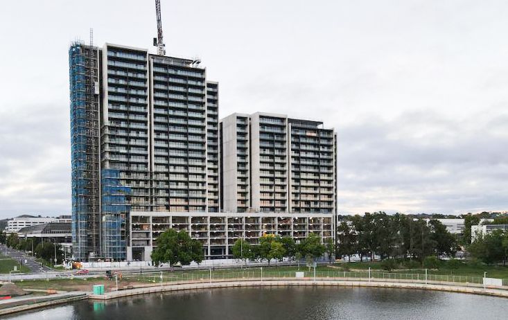 A Tall Building Behind A Lake — Precast Concrete Solutions in Queanbeyan East, NSW