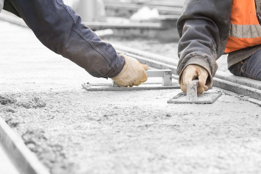 Two Construction Workers Working On A Concrete Surface — Precast Concrete Solutions in Queanbeyan East, NSW