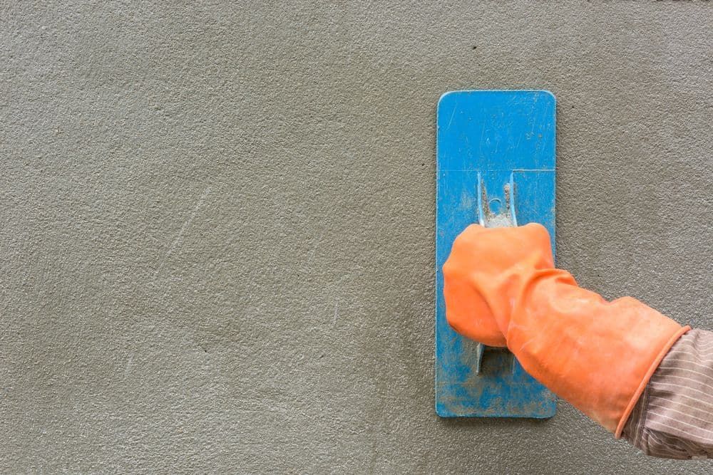 Plastering A Concrete Wall With A Trowel — Precast Concrete Solutions in Queanbeyan East, NSW