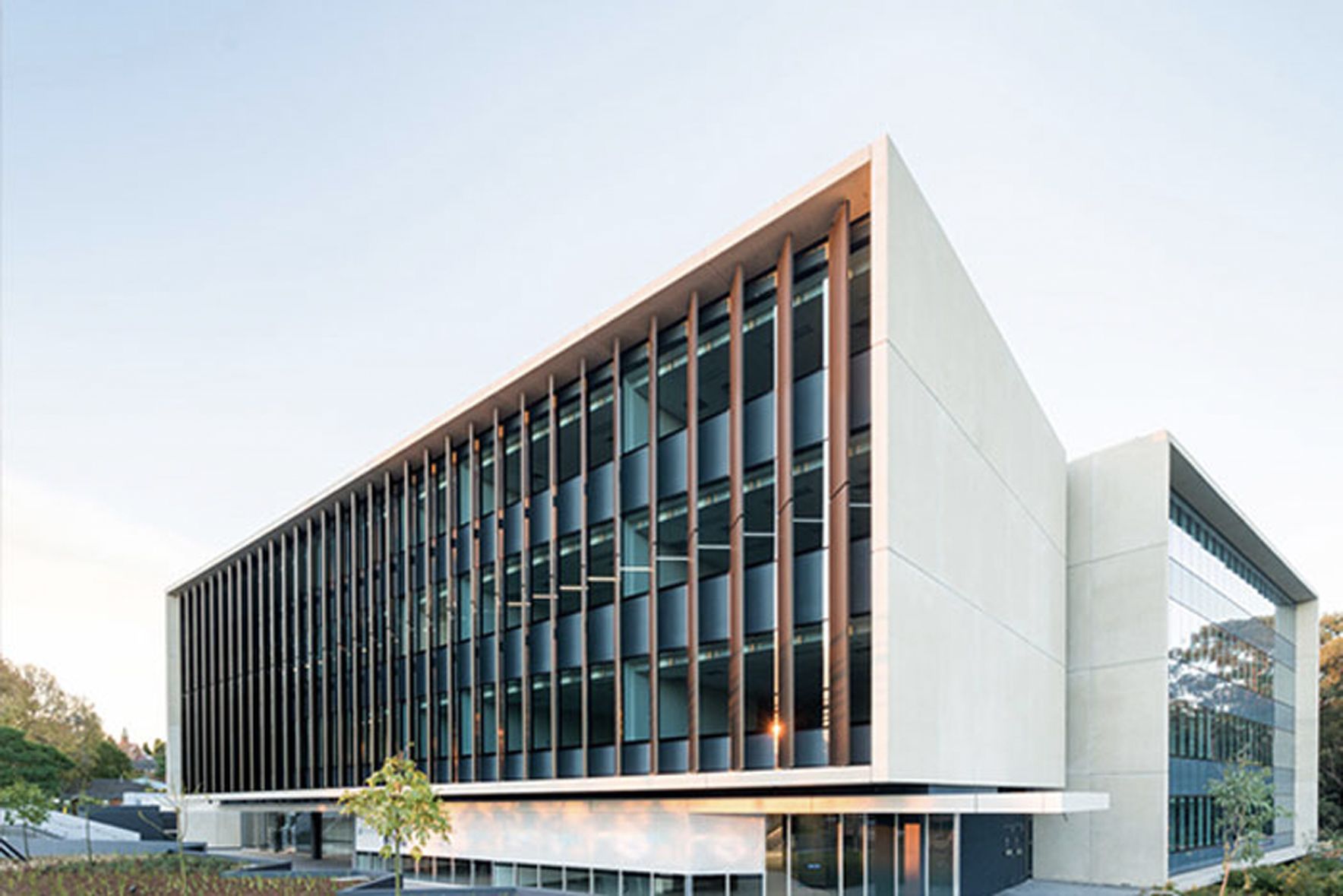 A White Building With A Small Tree Out the Front — Precast Concrete Solutions in Queanbeyan East, NSW