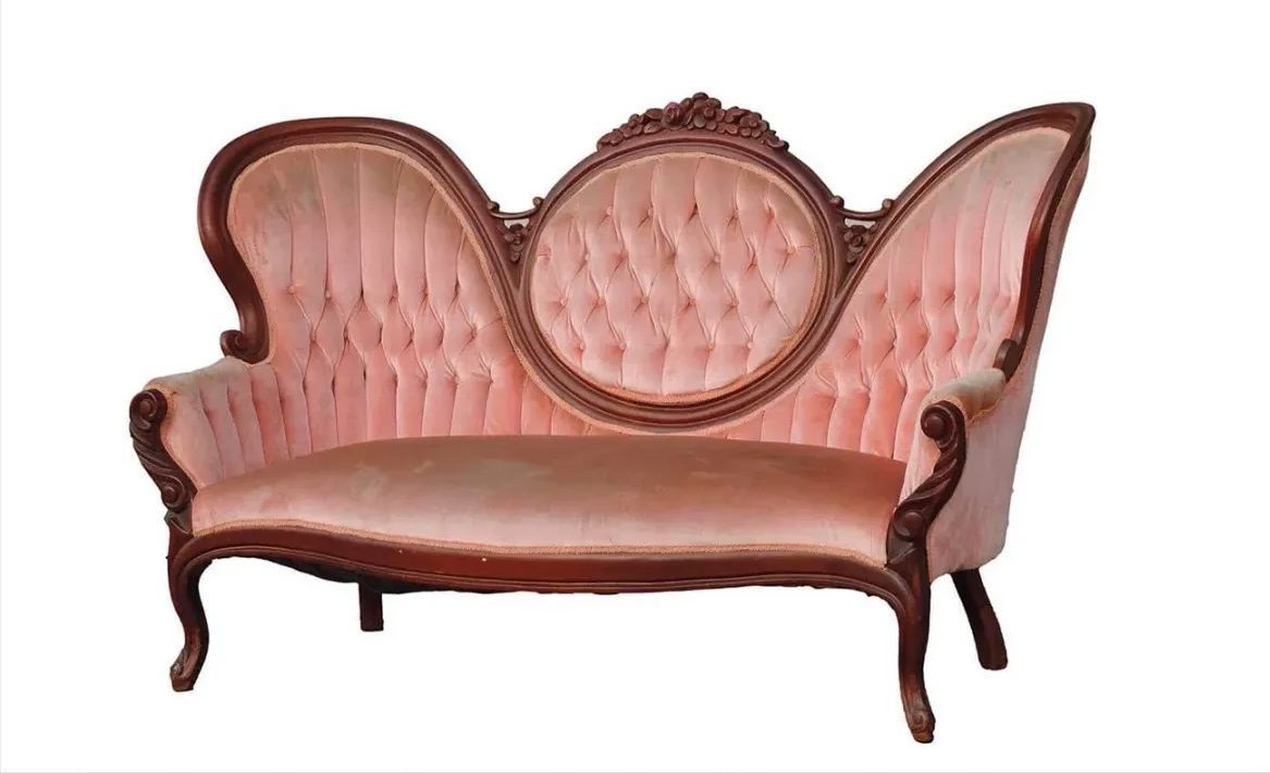 A pink couch with a wooden frame on a white background.