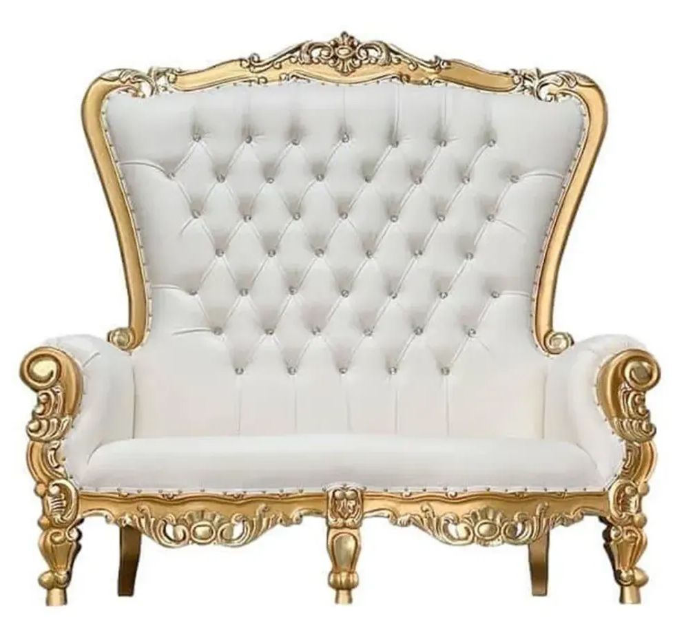 A white and gold couch on a white background.