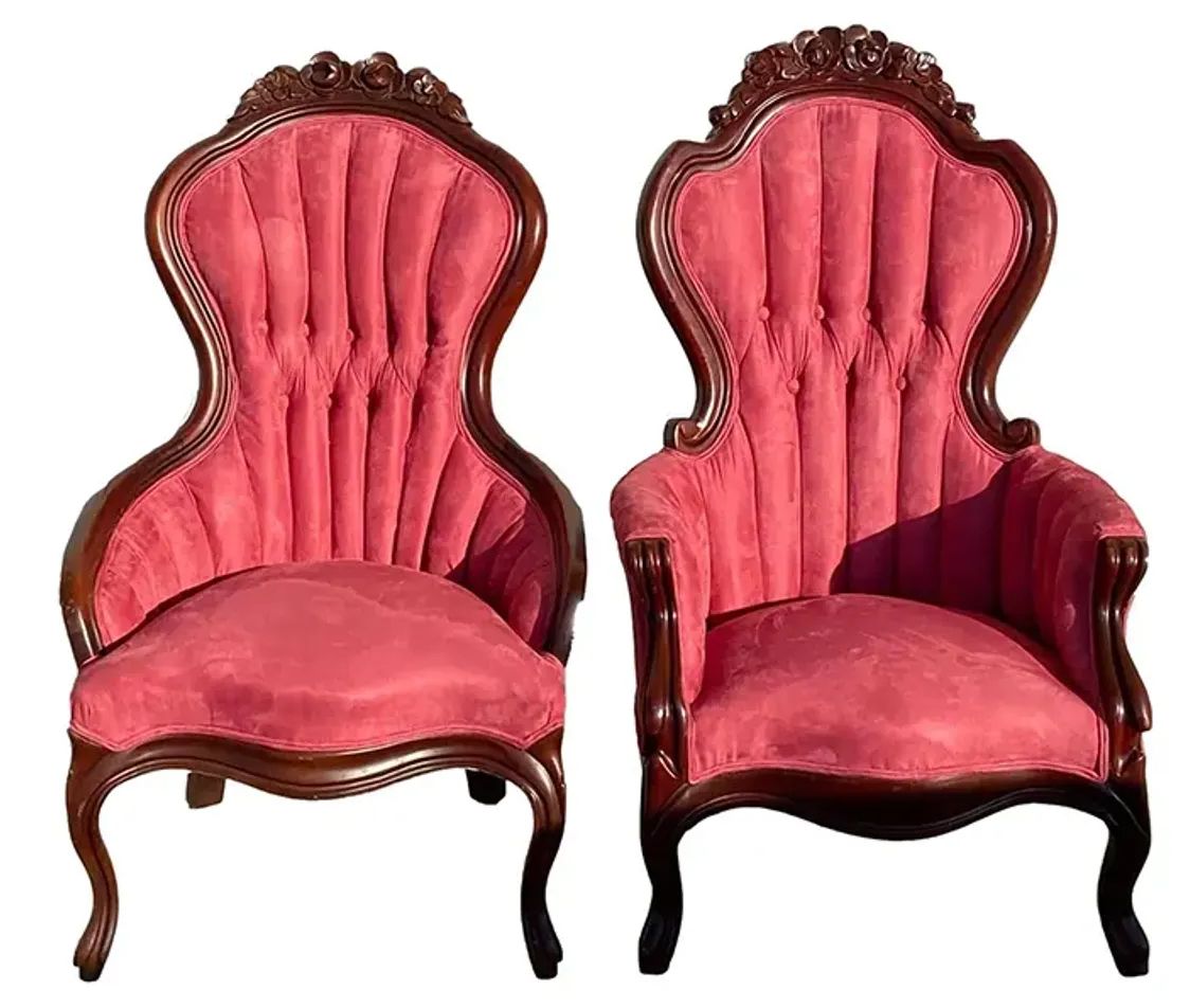 Two red chairs are sitting next to each other on a white background