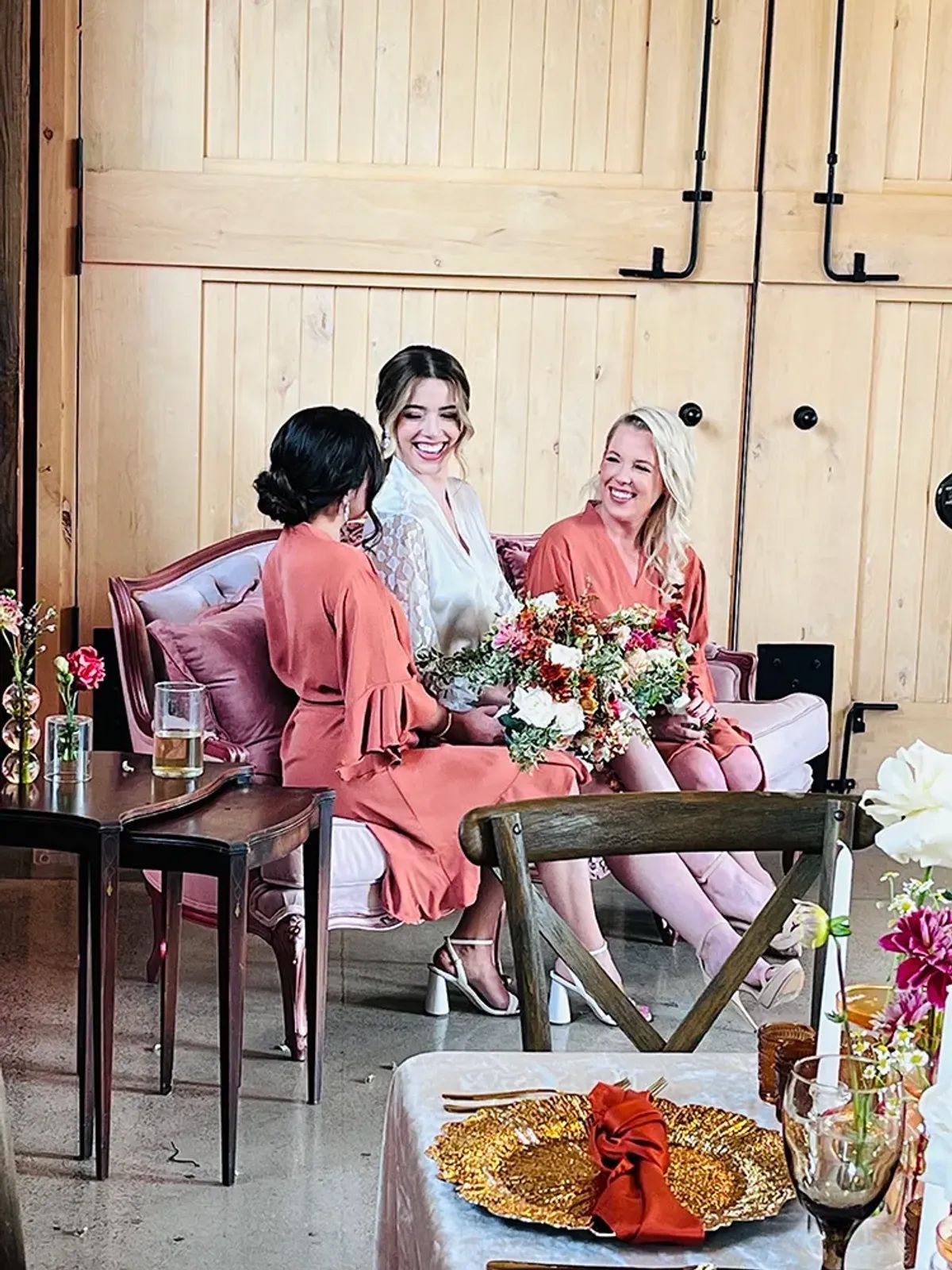 A group of women are sitting on a couch in a room.