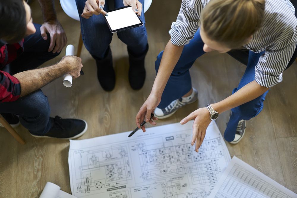 A Group Of People Are Looking At A Blueprint  — D&C Projects in Scone, NSW
