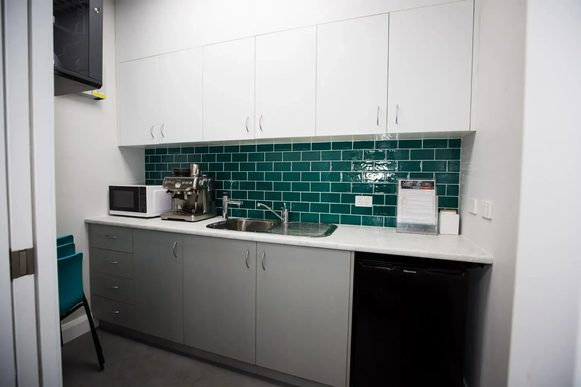 A Kitchen With White Cabinets, A Sink, A Microwave, And A Dishwasher — D&C Projects in Charlestown, NSW