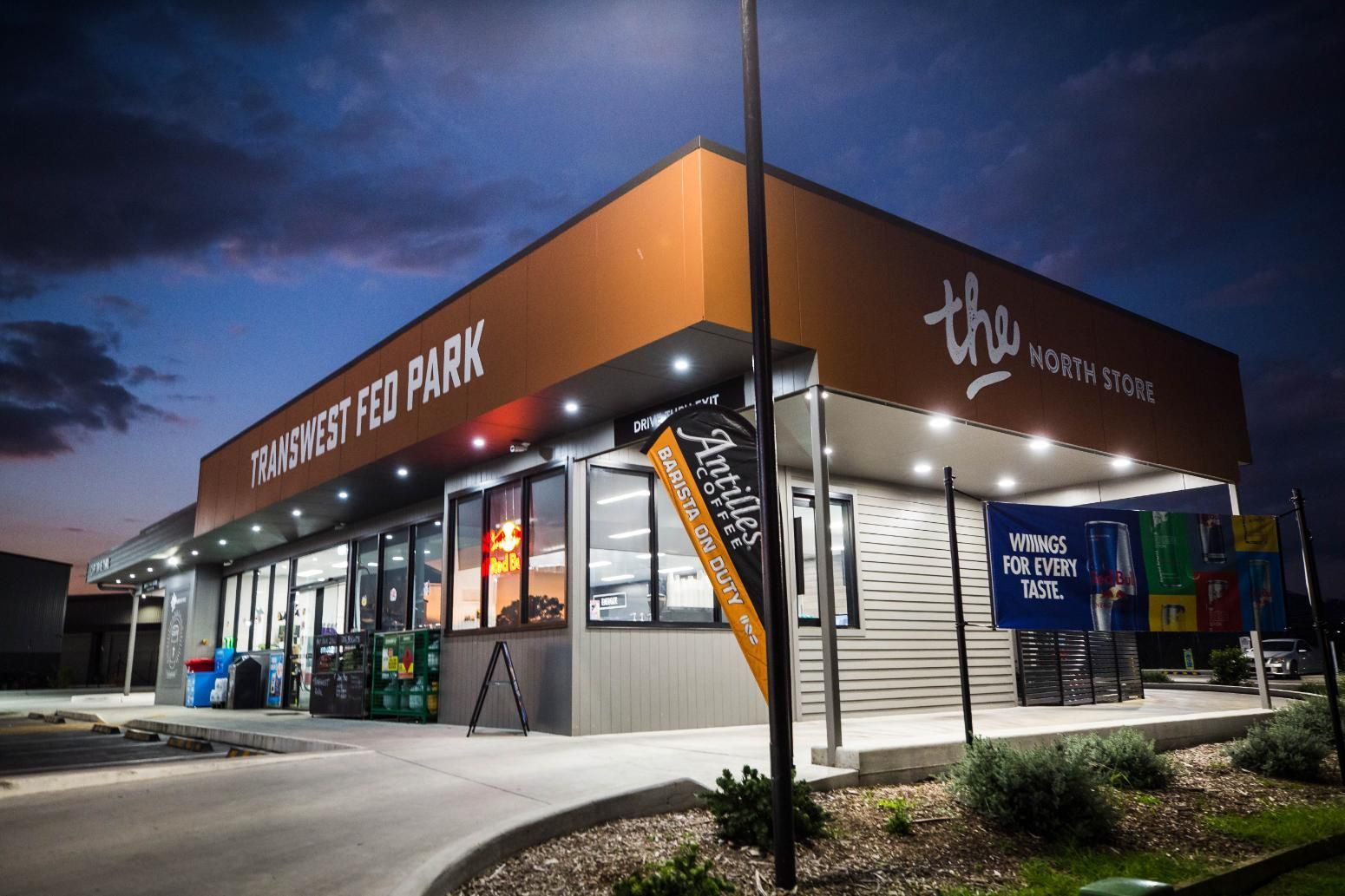 A Large Building with A Lot of Windows Is Lit up At Night — D&C Projects in Tamworth, NSW