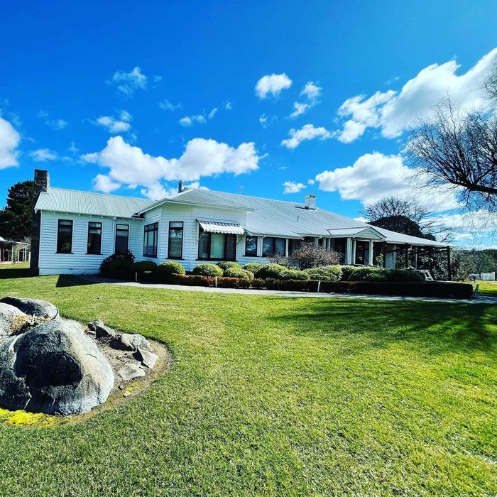 A Large White House With A Large Lawn In Front Of It — D&C Projects in Cooranbong, NSW