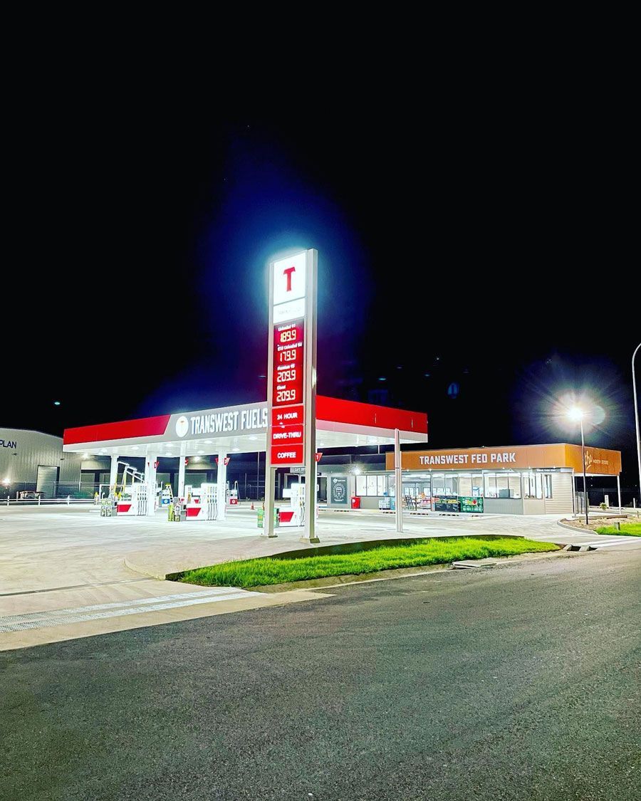 A Gas Station Is Lit Up At Night — D&C Projects in Nelson Bay, NSW