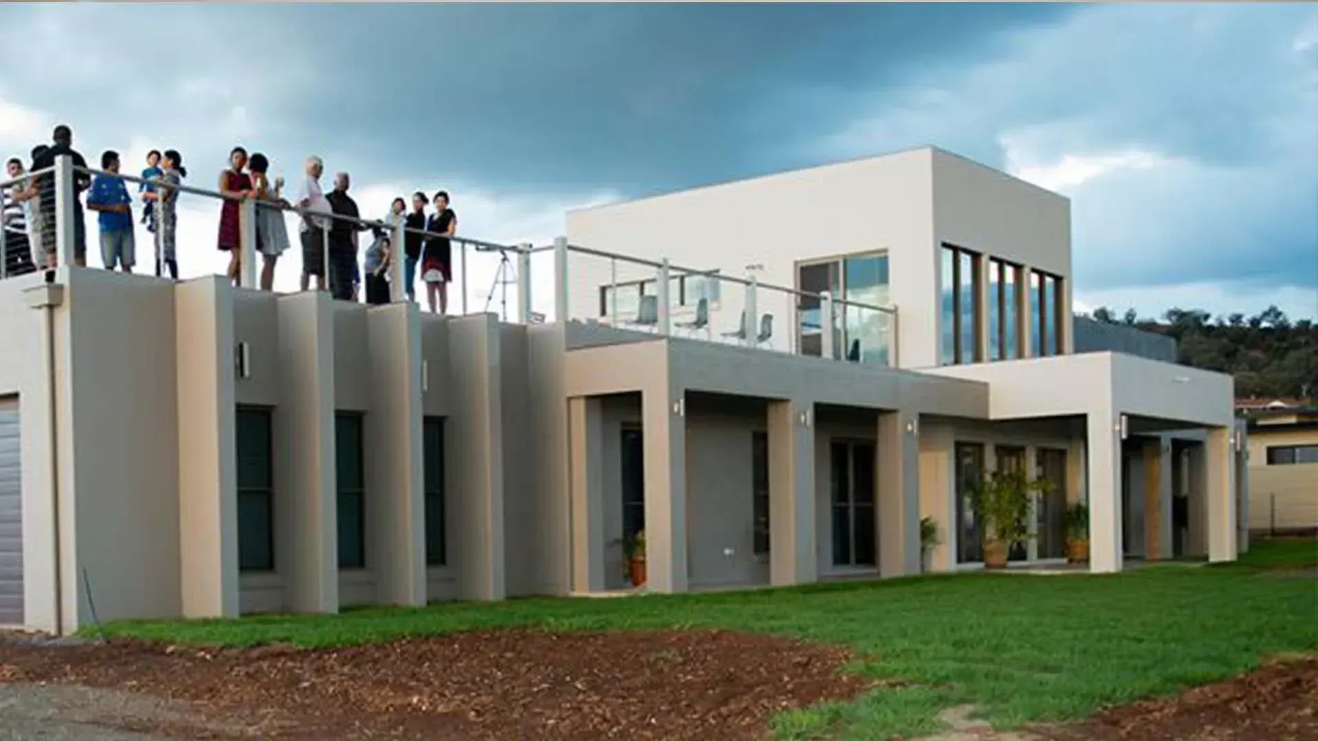A Group Of People Standing On Top Of A Large Building — D&C Projects in Charlestown, NSW