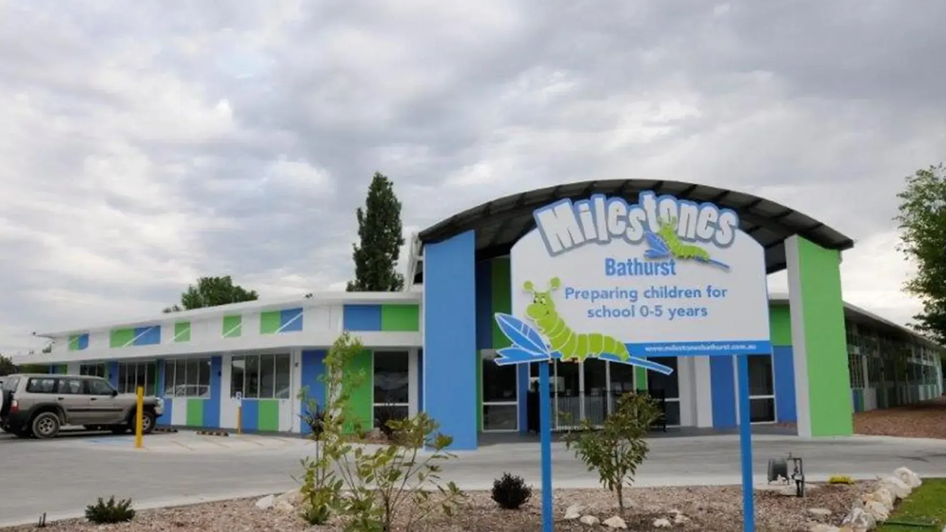 A Blue And Green Building With A Sign That Says Milestones — D&C Projects in Lake Macquarie, NSW