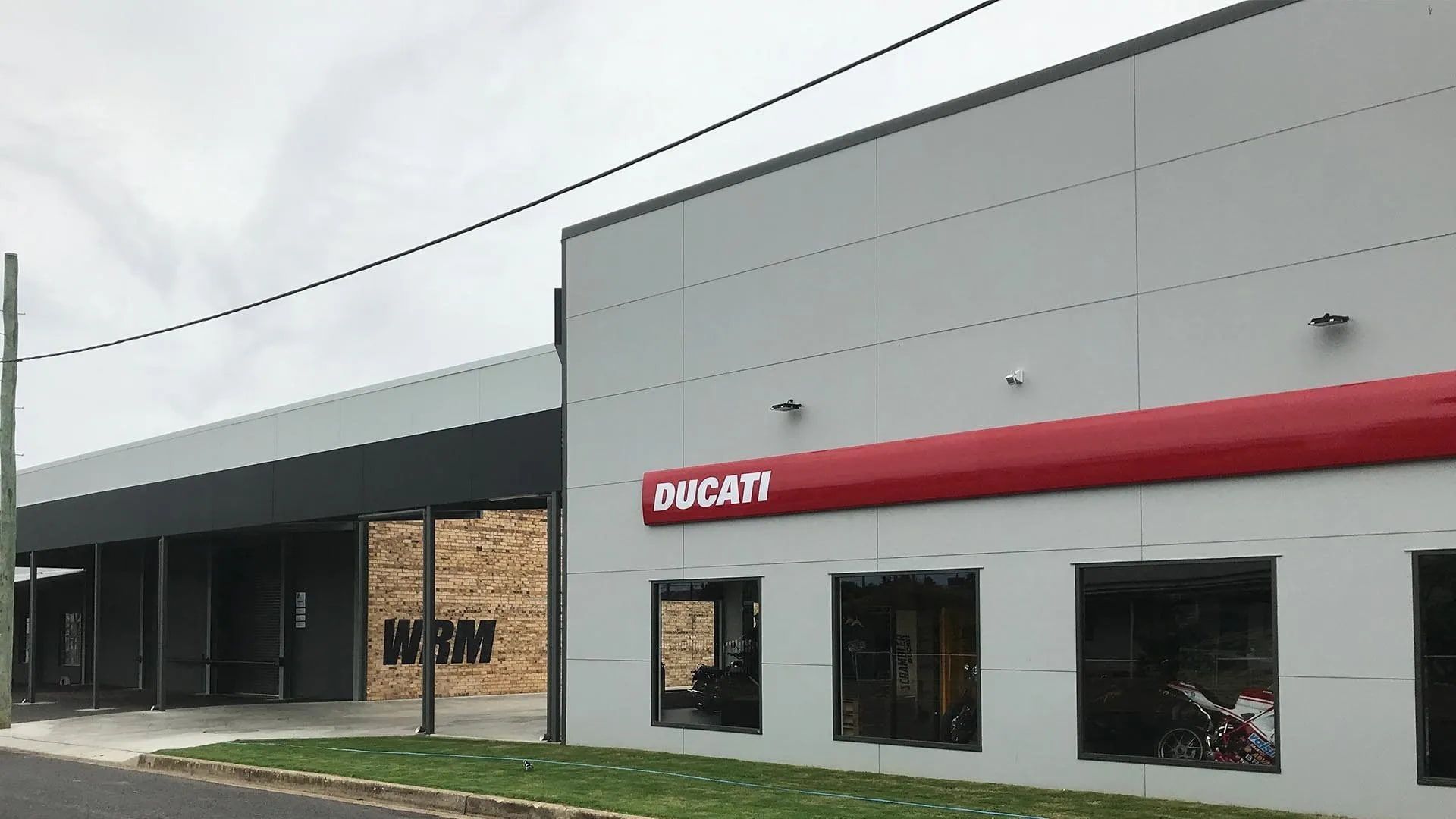 A Ducati Store With A Red Sign On The Side — D&C Projects in Tamworth, NSW