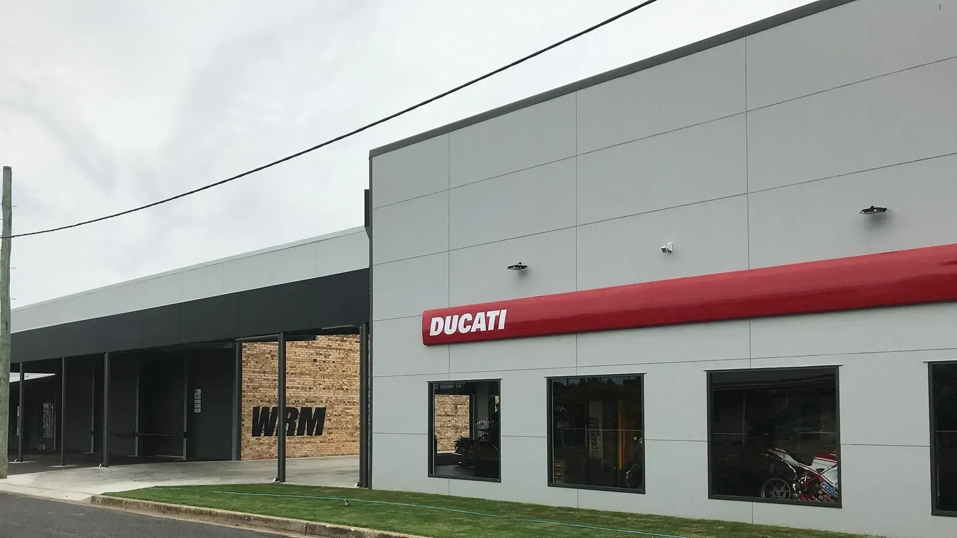 A Ducati Motorcycle Dealership Is Located On The Side Of A Building — D&C Projects in Dungog, NSW